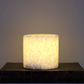 Vit matt marmorsten 8 cm som lyser varmt  - exklusiv marmorlampa i äkta natursten för mysig belysning. marmorlampa, bordslampa marmor, stilig bordslampa, snygg bordslampa, lampa i sten, marmorsten lampa, lysande marmor,